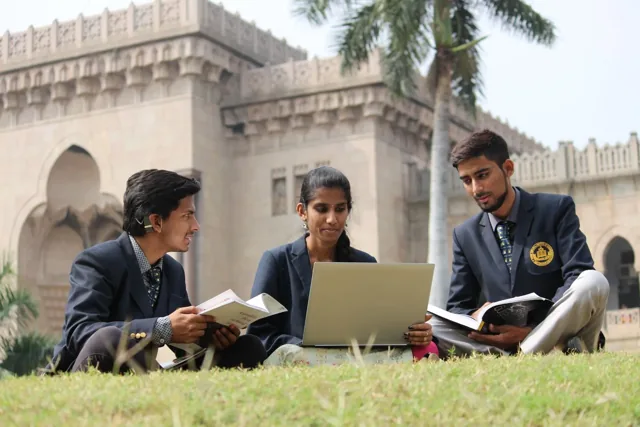 Students studying with books and a laptop, illustrative stock photo